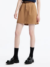 camel skirt and black leather shoes